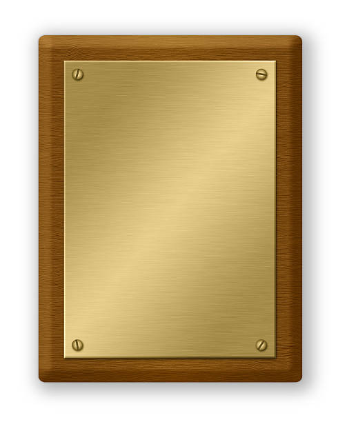 Gold And Wood Plaque Plaque or sign consisting of a gold plate on wood. Isolated on White. Clipping path included. memorial plaque photos stock pictures, royalty-free photos & images