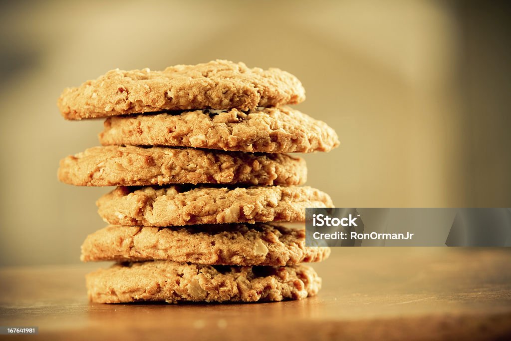 Cookies This is a stack of cookies shot on a wooden table top. Shot with a shallow depth of field and a warm retro color tone. Baked Stock Photo