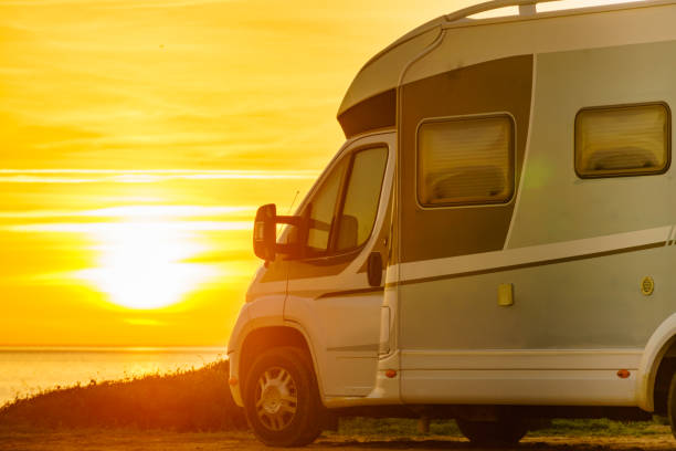 istock Camper vehicle on beach at sunrise 1676436516