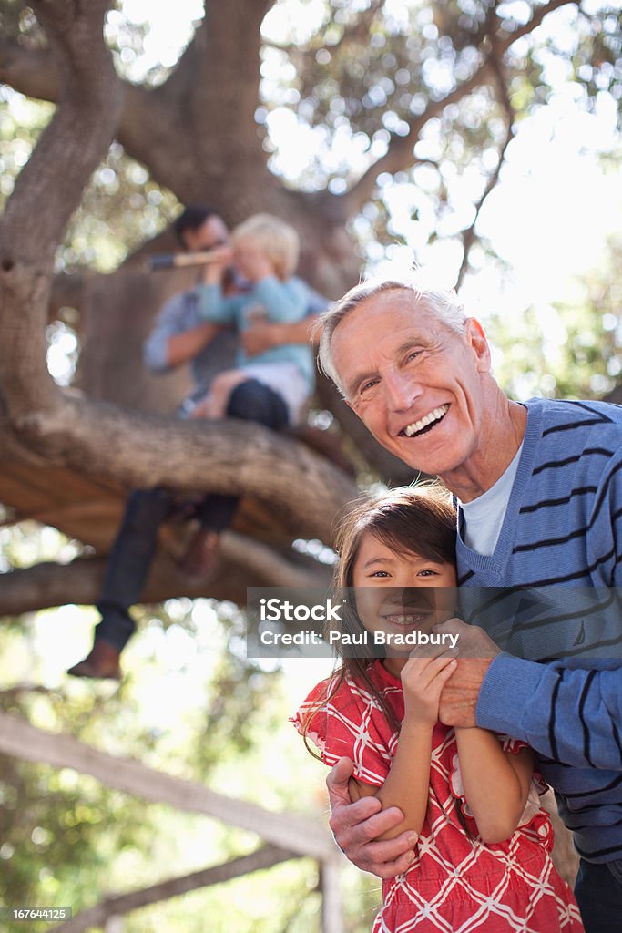 Older man hugging granddaughter outdoors  Family Stock Photo