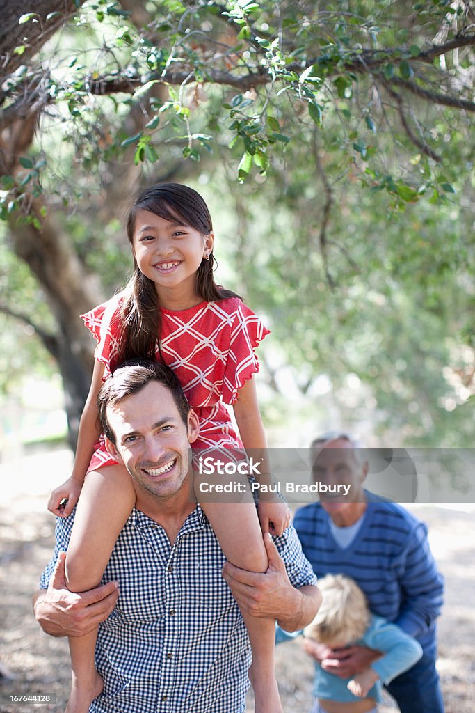 Father carrying daughter on his shoulders  30-34 Years Stock Photo