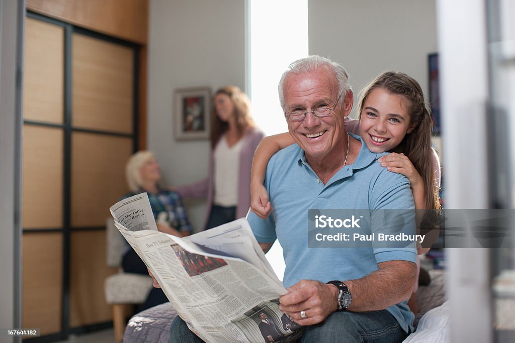 Girl hugging grandfather at home  Grandmother Stock Photo