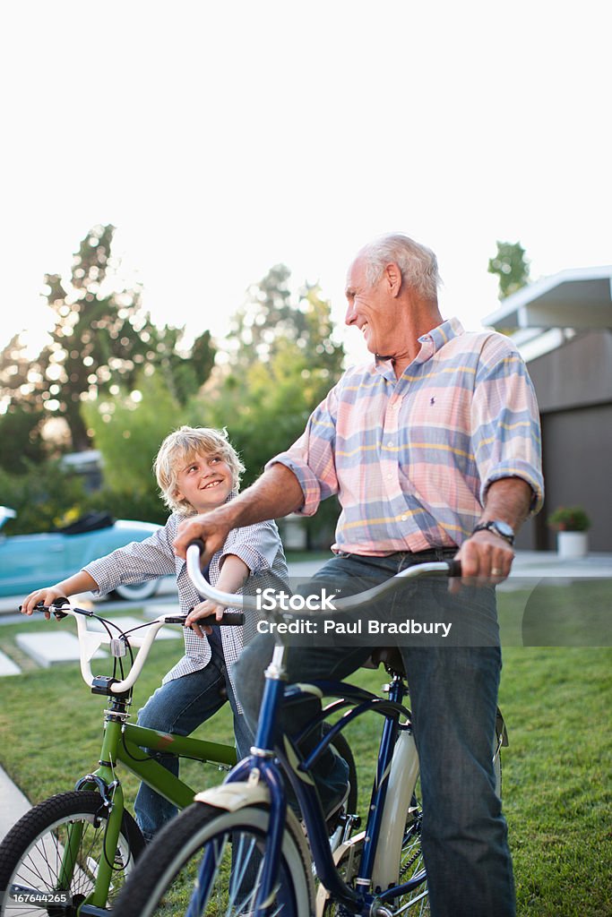 Mais homem e neto andar de bicicleta ao ar livre - Foto de stock de Avô royalty-free