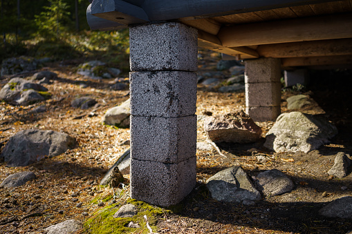 Concrete block pier foundation under a shed in nature, Finland.