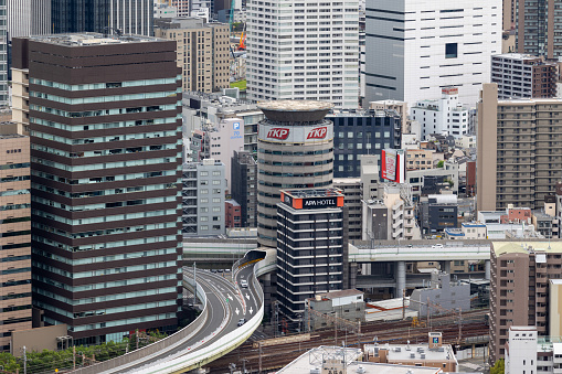 Osaka, Japan - September 2, 2023 : Gate Tower Building in Osaka, Japan. The Umeda exit of the Ikeda Route of the Hanshin Expressway system passes between the fifth through seventh floors of the building.