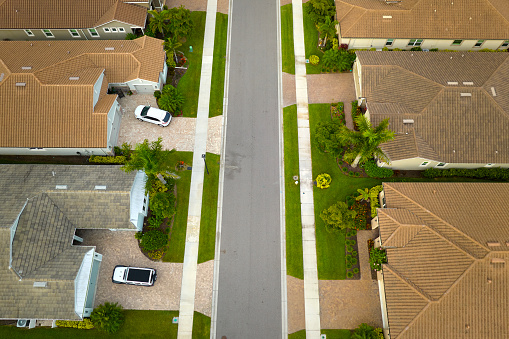 View from above of densely built residential houses in closed living clubs in south Florida. American dream homes as example of real estate development in US suburbs.