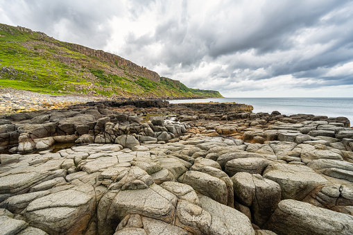 Stunning beach full of rocks eroded by the sea on the Isle of Skye in the Scottish Highlands