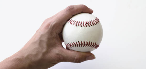 istock close up of hand holding a white baseball. 1676474934