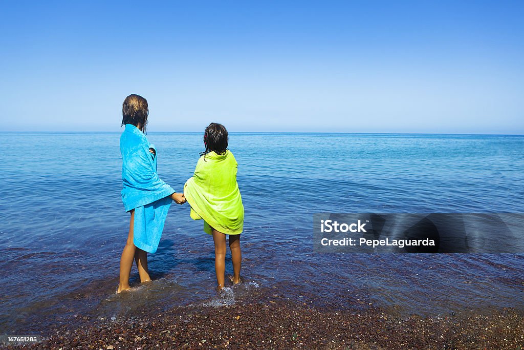 Две Сестры с видом на море - Стоковые фото Testing the water - английское выражение роялти-фри
