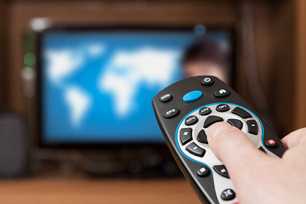 Tv remote with blurred tv background