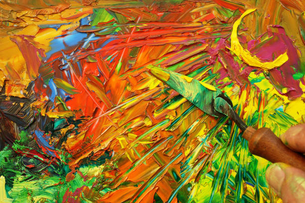 Close up view of abstract oil painting with visible oil paint scraper.