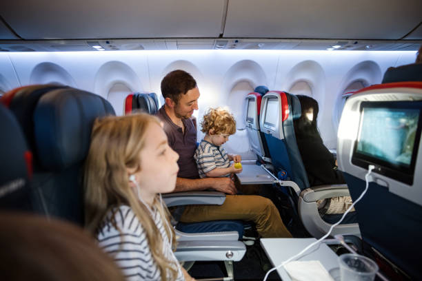 istock Father Riding Airplane With Toddler Son on Lap 1676537023