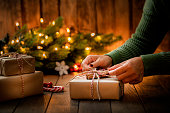 Woman's hands arranging a Christmas present