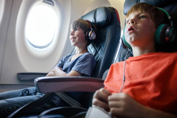 istock Brothers Riding Airplane Together 1676543437