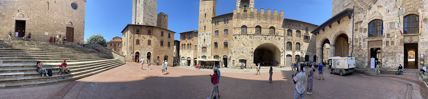San Gimignano, Italy - June 29 2023: Piazza del Duomo square panorama. San Gimignano is a small walled medieval hill town in the province of Siena, Tuscany.