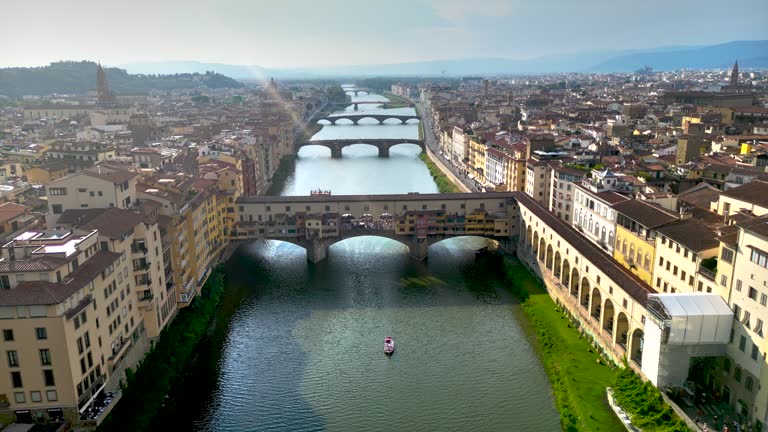 Aerial view of ponte vecchio bridge in Florence city, Florence bridge and river, Historically and Culturally Rich Italian Town Florence, Firenze - Aerial view of the city of Florence, Popular tourist destination in the world