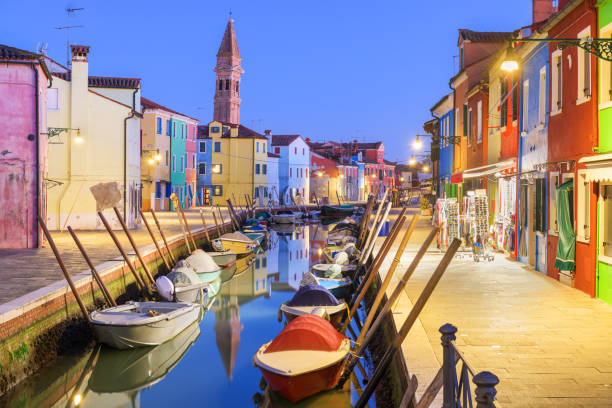Burano, Venice, Italy colorful buildings along canals at twilight.
