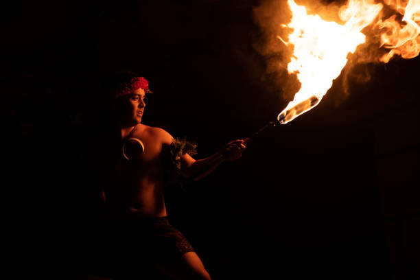 istock Hawaiian male dancer with torch in hands. 1676608495
