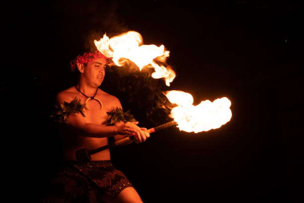 istock Hawaiian male dancer with torch in hands. 1676608497