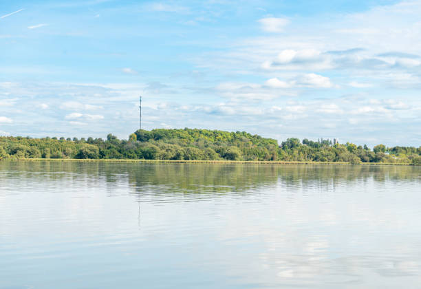 Calm lake with trees and blue sky