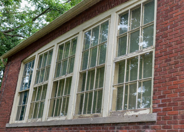 istock Old peeling paint in window frame on red brick building 1676624410
