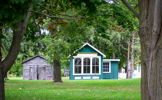 Old wooden cabins with trees