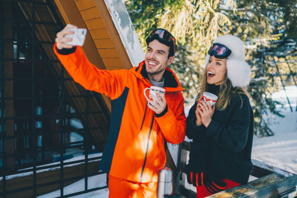 istock Couple on winter holiday taking selfie 1676629930