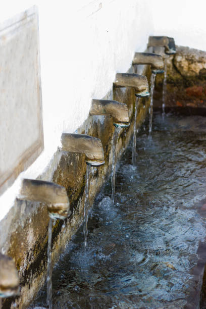 famous fountain of the twelve spouts in the village of fuenteheridos, sierra de aracena, andalusia, spain. - well fountain water pipe pipe imagens e fotografias de stock