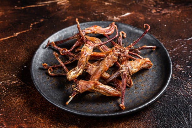 istock Spicy Dip fried duck tongue. Dark background. Top view 1676660578