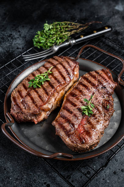 istock Grilled Top Blade or flat iron beef meat steaks. Black background. Top View 1676660931