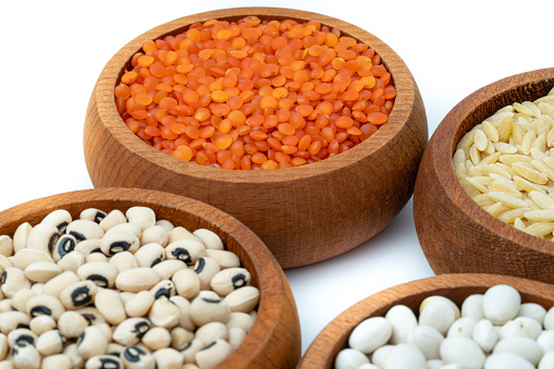 Wooden bowl full of porridge, cereals, lentils, peas and beans.