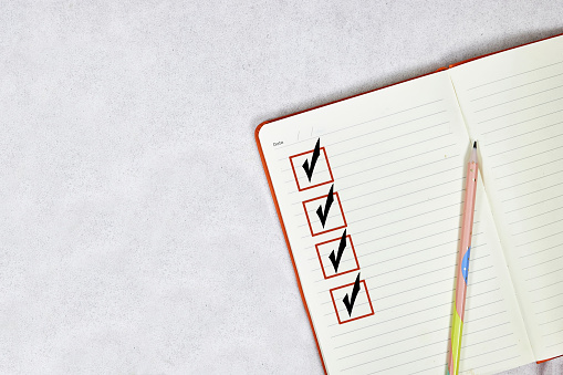 marking on checklist box on notebook. Checklist concept, copy space