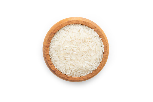 Rice in a wooden bowl isolated on white background.
