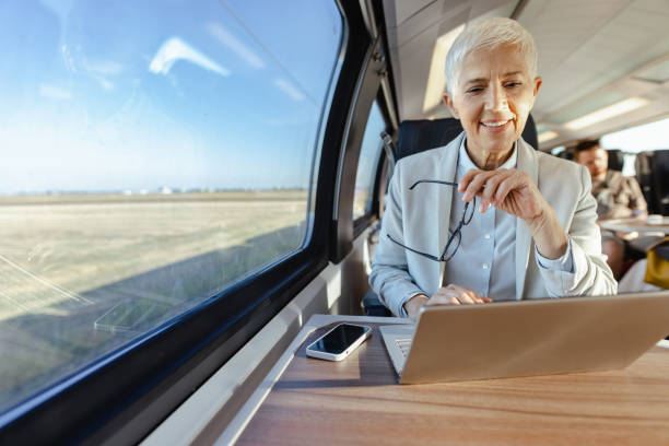 istock Senior businesswoman using laptop and while commuting to work 1676706941