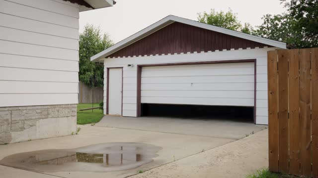 Garage door opening in the driveway of a residential house