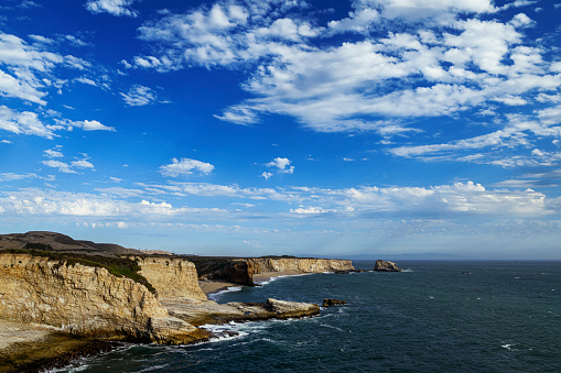 Wide coastal view of Panther and Hole in the Wall beaches under cloudy sky.\n\nTaken from Northern California, USA