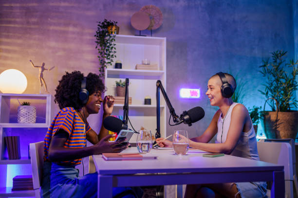 istock Two cheerful podcasters are sitting in a little home podcast studio. 1676720645