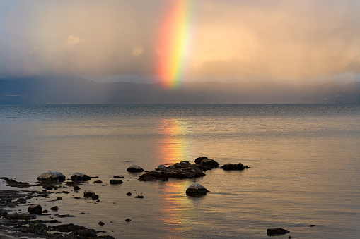 View of a rainbow over the Villarrica lake in the Araucania Region, Chile