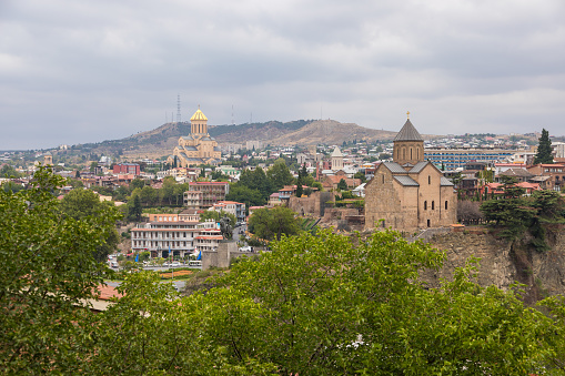 Georgia, Tbilisi - 30 August 2019: The Holy Trinity Cathedral of Tbilisi, commonly known as Sameba. The main cathedral of the Georgian Orthodox Church. old historic town around.