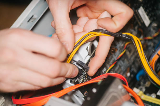 istock Professional system administrator holds in hands sockets connectors of standard power supply unit. man repairing and assembling computer. concept of repair computer. Selective focus 1676802158