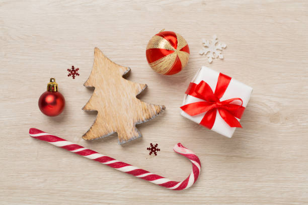 istock Miniature christmas tree with gift box and decor on wooden background 1676824973