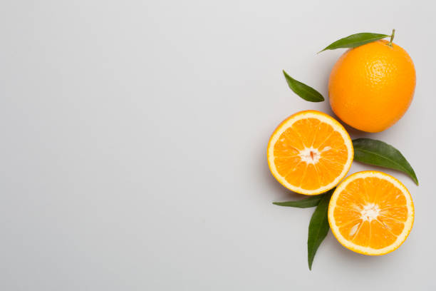 istock Flat lay with fresh oranges and leaves on color background 1676833647