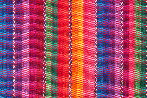 The picture displays a vibrant Latin tapestry woven with a riot of colors, creating an eye-catching textile background.