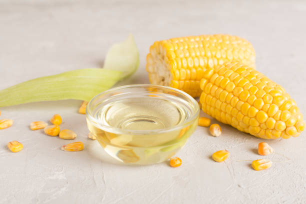 istock Corn oil with fresh cobs on wooden table 1676844545