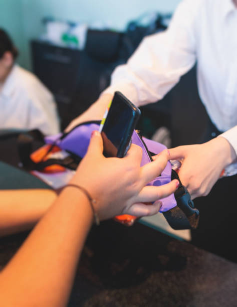 istock Process of checking in on a conference congress forum event, registration desk table, visitors and attendees receiving a name badge and entrance wristband bracelet and register electronic ticket 1676869047