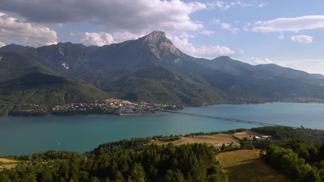 Aerial view of Serre-Poncon lake with Savines-le-Lac village and Grand Morgon peak in summer. Durance Valley in Hautes-Alpes (Alps), France