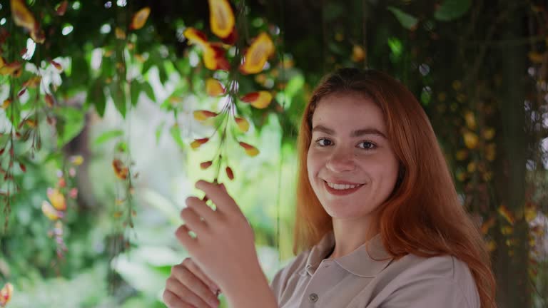 Portrait of a botanist analyzing flowers in a garden center