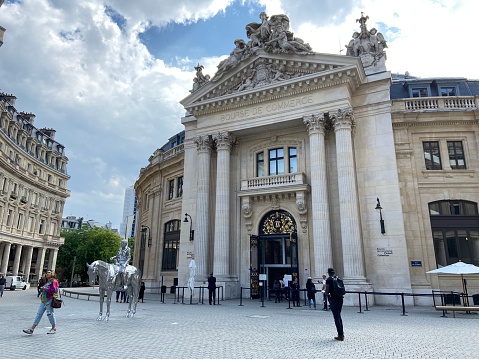 Paris, France - June 22, 2022 : View of people on the plaza in front of the entrance to the Bourse de Commerce - Pinault Collection on a summer day in Paris, France