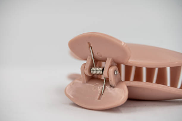 istock Pink Claw Hair Clip Spring Close Up Macro Studio White Background 1676949434