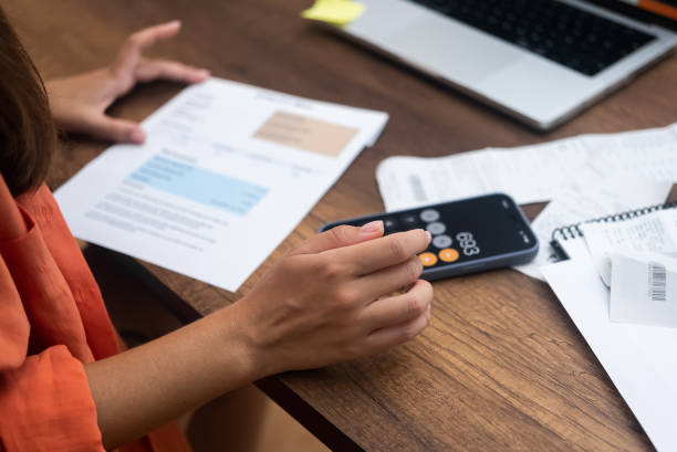 istock lady with payment receipts, pays household utility bills online from home using her trusty laptop 1676982524